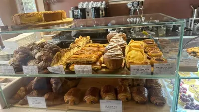 two plates of pastries on a table in front of a building at Palermo Houses in Palermo