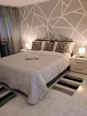 a bedroom with a large bed and two lamps at casa centro storico O Capu in Palermo
