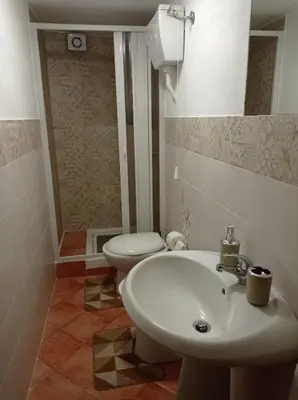 a bathroom with a white sink and a toilet at casa centro storico O Capu in Palermo