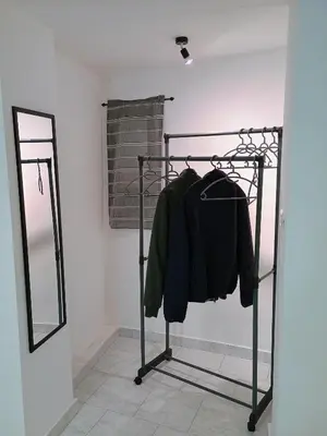 a clothes rack in a room with a mirror at casa centro storico O Capu in Palermo