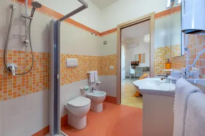 a bathroom with a toilet and a sink and a shower at B&B Armonie in San Vito lo Capo