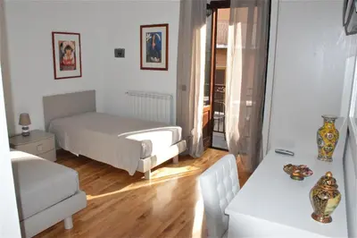 a bedroom with a bed and a table in a room at B&B Porta delle Madonie in Campofelice di Roccella