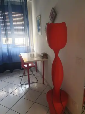 a room with a table and a red cat statue at Dolce casa centro storico di Palermo new 2023 in Palermo