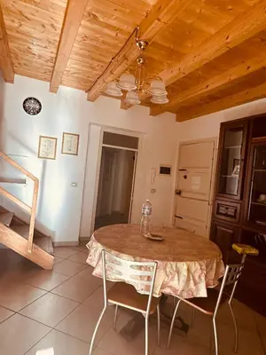 a dining room table with chairs and a ceiling at Casa nonno Enrico in via Oreto in Palermo