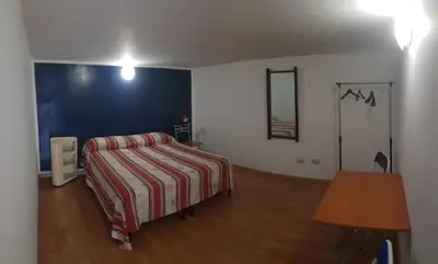 a bedroom with a bed and a table in it at Casa nonno Enrico in via Oreto in Palermo