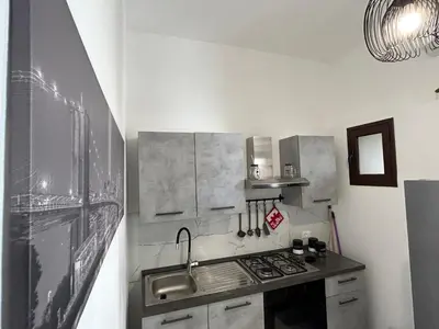 a kitchen with a sink and a stove at La Cupola - casa vacanze n 8 in Termini Imerese