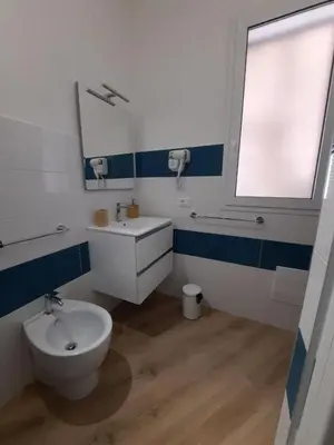 a bathroom with a toilet and a sink and a window at b&b Lastracu in Castellammare del Golfo