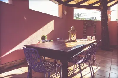 a wooden table and chairs in a room with a table at Villa Lidia in Balestrate