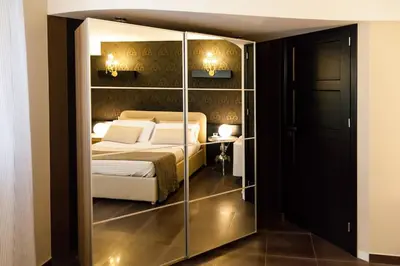 a bedroom with a bed in a glass closet at Villa Lidia in Balestrate