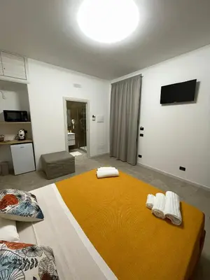 a bedroom with a large bed with towels on it at Fiori di Quercia in Carini
