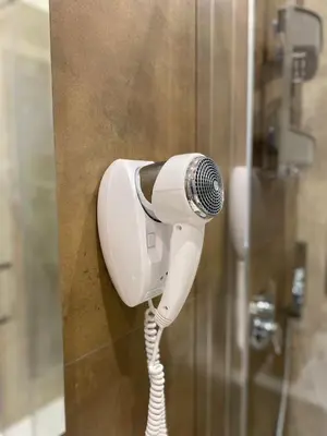 a hair dryer hanging on the wall of a shower at Fiori di Quercia in Carini
