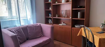 a living room with a purple couch and a table at Casa Vacanza Edy in Palermo