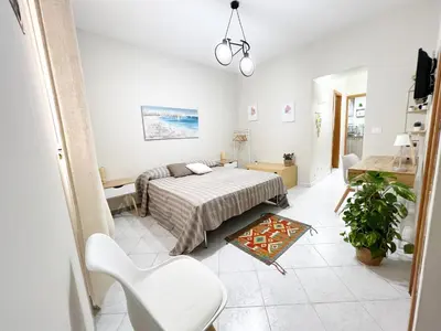 a bedroom with a bed and a living room at La casa di Angela in Monreale