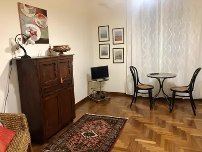 a living room with a cabinet and a table and chairs at G&G ROOMS in Palermo