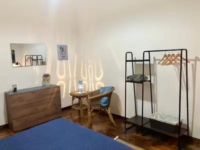 a room with a bed and a dresser and a mirror at G&G ROOMS in Palermo