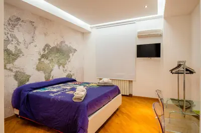 a bedroom with a bed and a map on the wall at Casamu' Management Apartment Palermo in Palermo