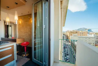 a balcony with a view of a city at Casamu' Management Apartment Palermo in Palermo