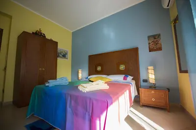 a bedroom with a colorful bed with towels on it at Dolce Conca D'Oro B&B in Palermo