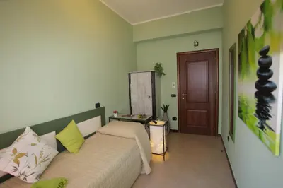 a bedroom with a bed with green walls at Dolce Conca D'Oro B&B in Palermo