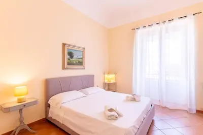 a bedroom with a bed and a window at Viola's Luxury House in Palermo