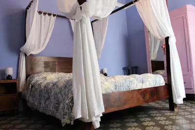 a bedroom with a canopy bed with curtains at La Via delle Biciclette in Palermo