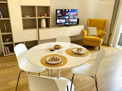 a white table and chairs in a living room at The Unique Loft Maqueda - in the city centre in Palermo
