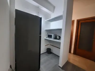 a black refrigerator in a room with a microwave at Domus Oreto in Palermo