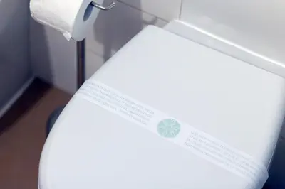 a toilet in a bathroom with a sticker on it at Arco di Bonello Cattedrale in Palermo