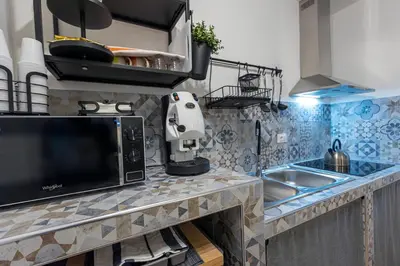 a kitchen counter with a microwave and a sink at Arco di Bonello Cattedrale in Palermo