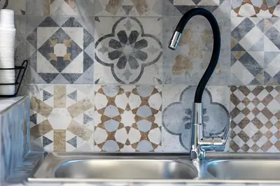 a kitchen sink with a water faucet at Arco di Bonello Cattedrale in Palermo