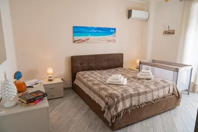 a bedroom with a bed with two towels on it at Nelly Casa Vacanze in Porticello