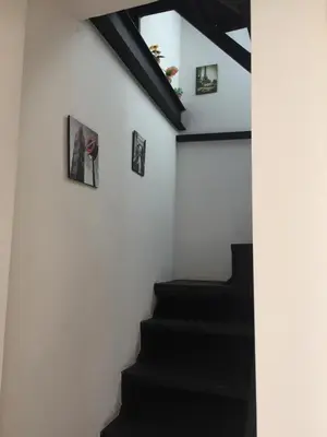 a staircase in a house with pictures on the wall at La Cupola in Palermo