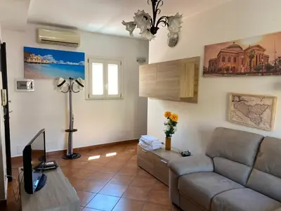 a living room with a couch and a table at La Cupola in Palermo