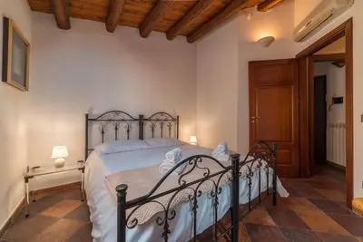 a bedroom with a bed with a metal frame at A Casa del Gioielliere in Palermo