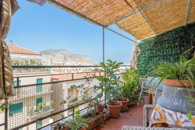 a balcony with plants and a view of the city at Artist penthouse 2 in Palermo