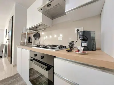 a kitchen with a stove and a counter top at Vespucci Holiday in Casteldaccia