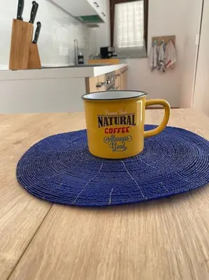 a yellow coffee cup sitting on top of a table at Casamartú Apartment in Palermo