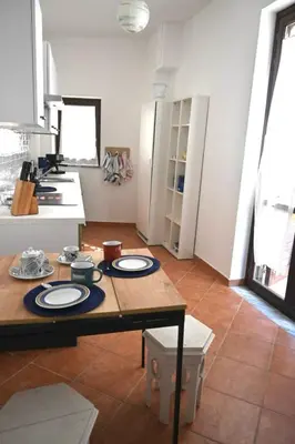 a kitchen with a table with plates on it at Casamartú Apartment in Palermo