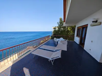 a balcony with two lounge chairs and the ocean at Sea Sicily View in Bagheria
