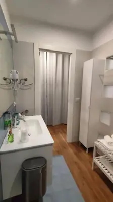 a white bathroom with a sink and a closet at GIO&GIO central house in Palermo