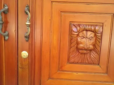 a wooden door with a lion carving on it at Il Terrazzo Di Oleandri in Bagheria