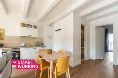 a kitchen and dining room with a wooden table and chairs at Casa Valverde in Centro Storico by Wonderful Italy in Palermo