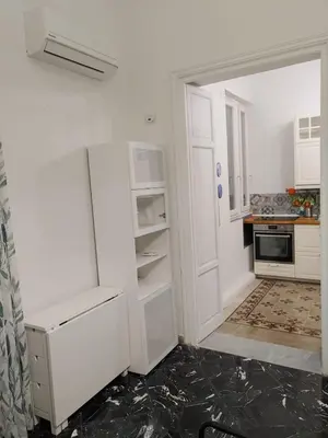 a kitchen with white cabinets and a refrigerator at B&B da Nonna Cicci APT vicino al Teatro Massimo in Palermo