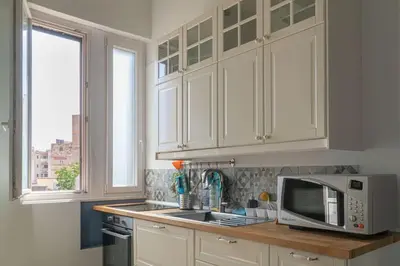 a kitchen with white cabinets and a microwave at B&B da Nonna Cicci APT vicino al Teatro Massimo in Palermo