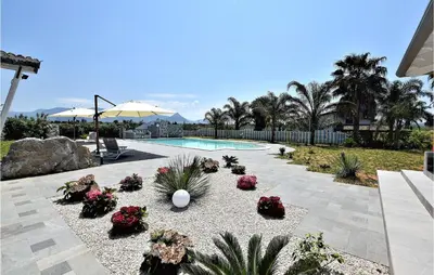 a backyard with a swimming pool and some flowers at Awesome Home In Partinico With Wi-Fi in Partinico