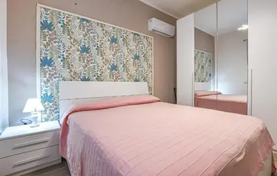 a small bedroom with a bed and a mirror at Awesome Home In Partinico With Wi-Fi in Partinico