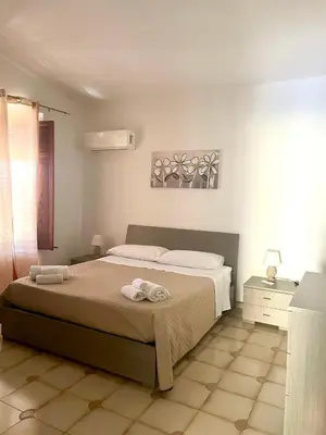 a bedroom with a bed with two towels on it at Villa Nasus in Carini