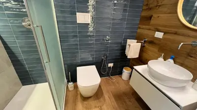 a bathroom with a white toilet and a sink at Le Stanze del Re in Palermo