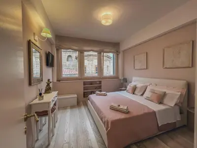 a bedroom with a large bed and a table at [jarase] nel centro di Palermo in Palermo