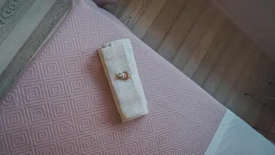 a white book sitting on a pink rug on a floor at [jarase] nel centro di Palermo in Palermo